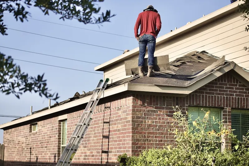 Professional roofer working on a residential roof in Waldrop Crossroads